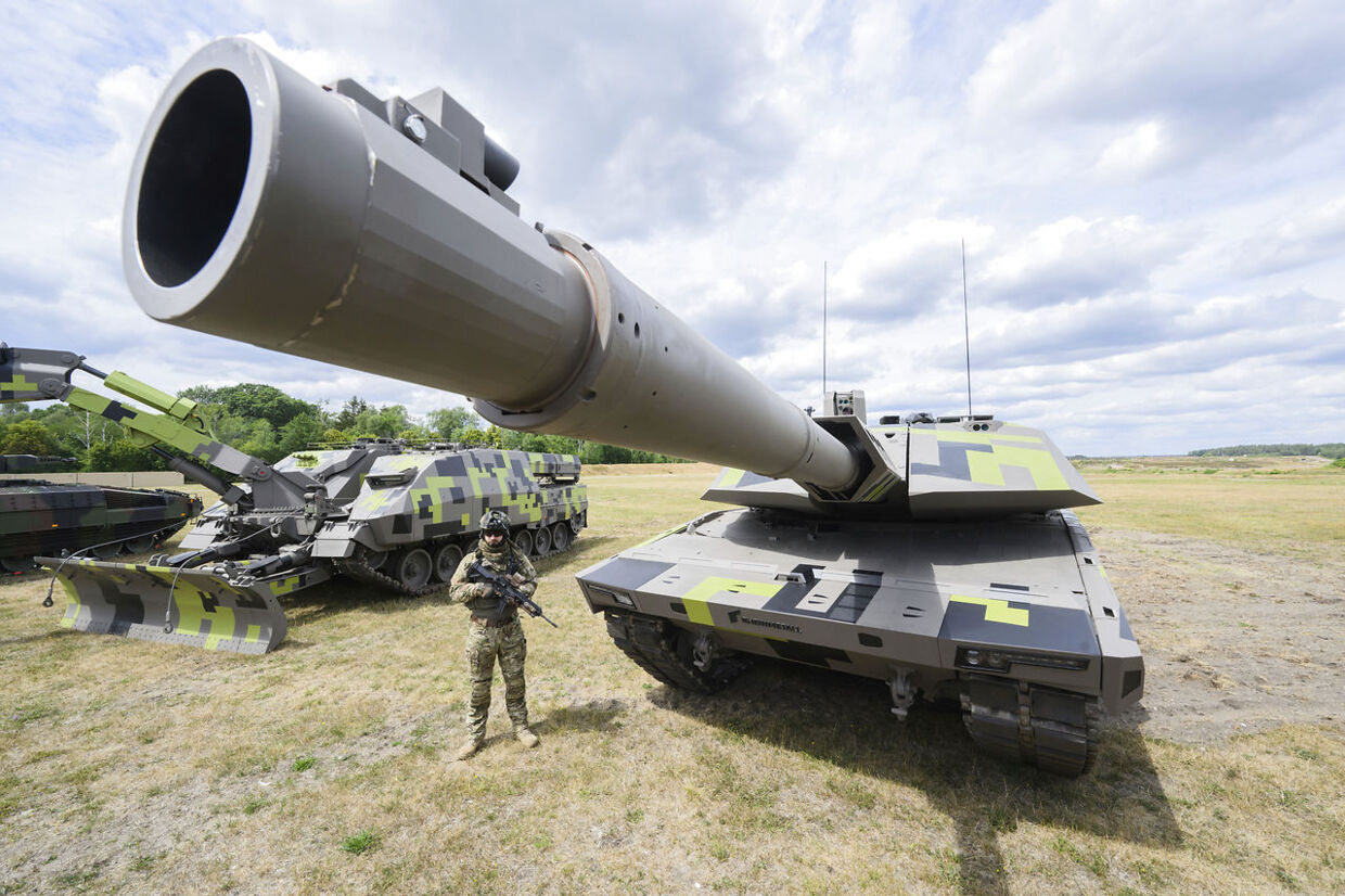 14 July 2022, Lower Saxony, Unterl'': An "infantryman of the future" stands next to a Panther KF51 main battle tank from the Rheinmetall armaments group during a tour of the Rheinmetall plant in Unterl'' on the occasion of the summer trip by Lower Saxony's economics minister. The newly developed Panther is one of the most advanced weapons systems in the world. Photo by: Julian Stratenschulte/picture-alliance/dpa/AP Images